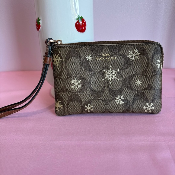 Coach Handbags - Coach Brown Wristlet with Snowflake Design